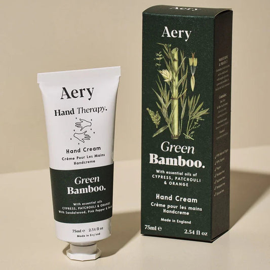 Aery Green Bamboo Hand Cream packaging and tube, with white box featuring bamboo graphics and a Cypress Patchouli and Orange hand cream tube.