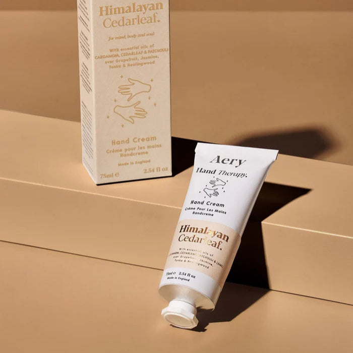 Aery Himalayan Cedarleaf Hand Cream packaging and tube, with Cedar Patchouli and Lemon scent, displayed on a neutral background.