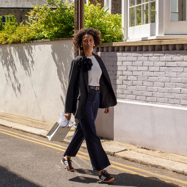 Woman walking on a street in an urban setting