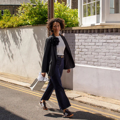 Woman walking on a street in an urban setting