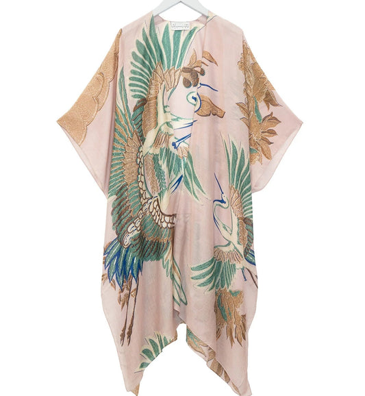 Pink kimono-style garment with peacock and leaf pattern on a white background