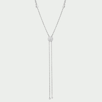 Silver necklace with a central pendant on a light gray background