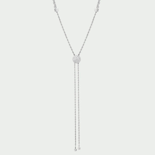 Silver necklace with a central pendant on a light gray background